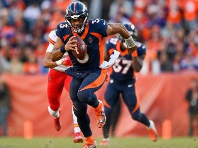 Russell Wilson is running with a football in his hand.